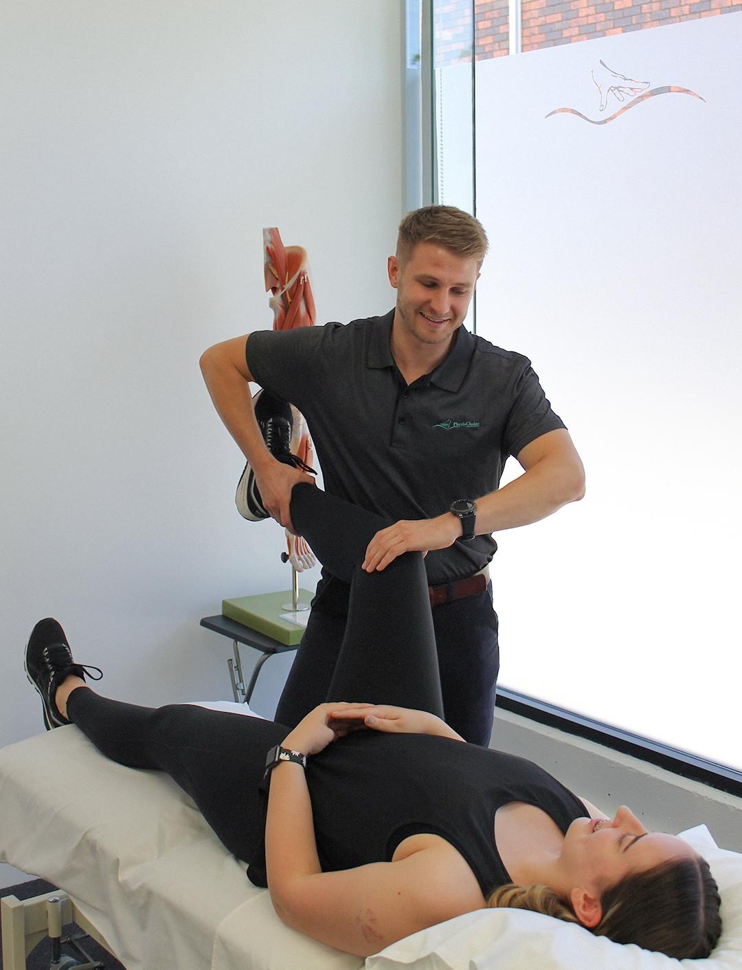 Physiotherapist assisting customer with injury